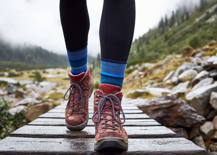 Use protective clothing to prevent Lyme disease: woman walking with longs pants outdoor.