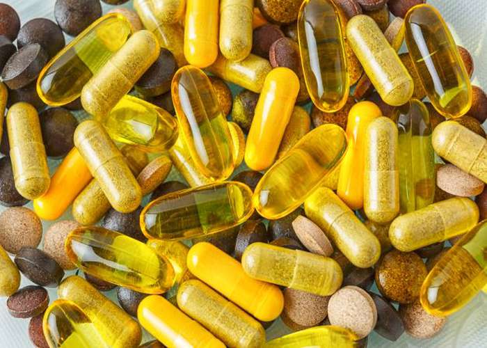 Take vitamins for Lyme disease: different types of vitamin capsules.