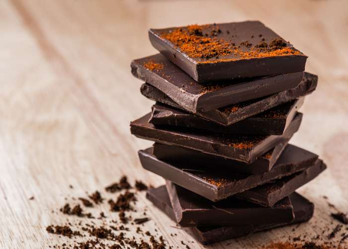 Dark chocolate for Alzheimer: pieces of dark chocolate stacked on top of each other.
