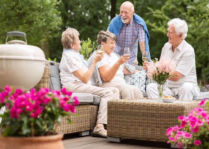 Engage in social activities for Alzheimer: two elderly couples hanging out and spending good times together.