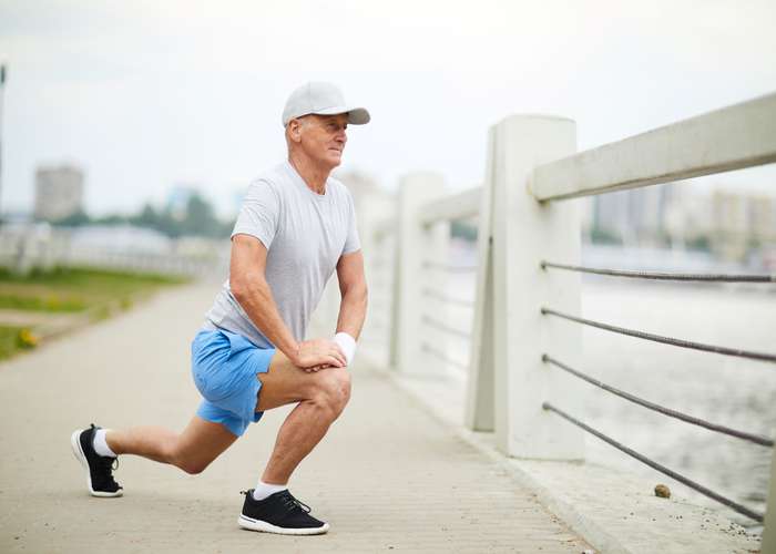 Exercise regularly to improve heart health: middle aged man doing outdoor sports.