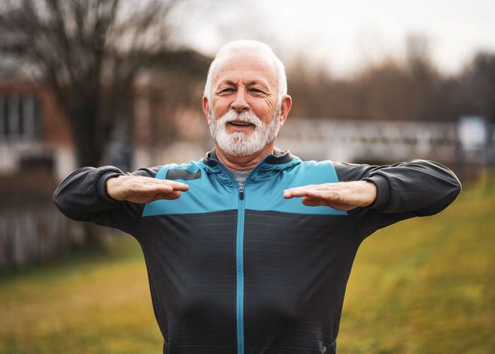 Do physical activity for arthritis: elder man doing sports outdoor.