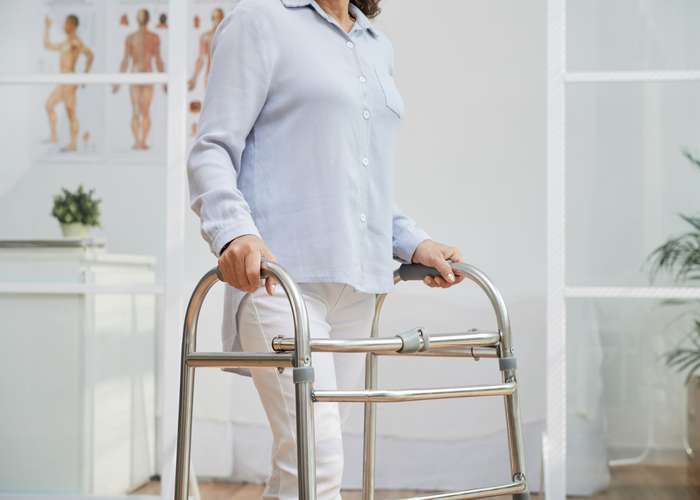 Use assistive device for Parkinson: person using assistive device to walk.