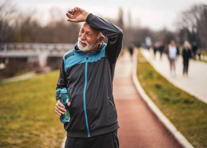 Exercise for Parkinson: senior man doing sports outdoor.