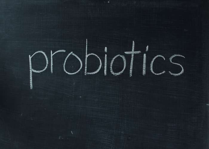 Eat probiotic rich foods for IBS: probiotics written on a black board.