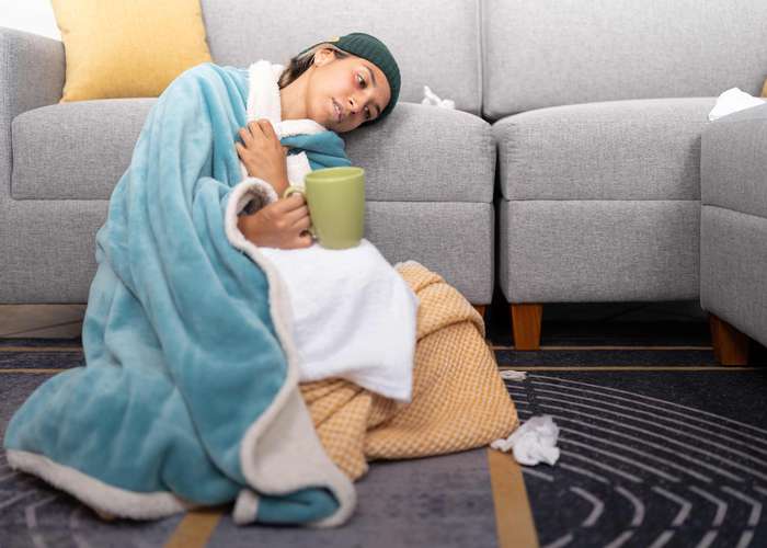 Woman suffering from food poisoning resting: make sure you rest properly if you have food poisoning