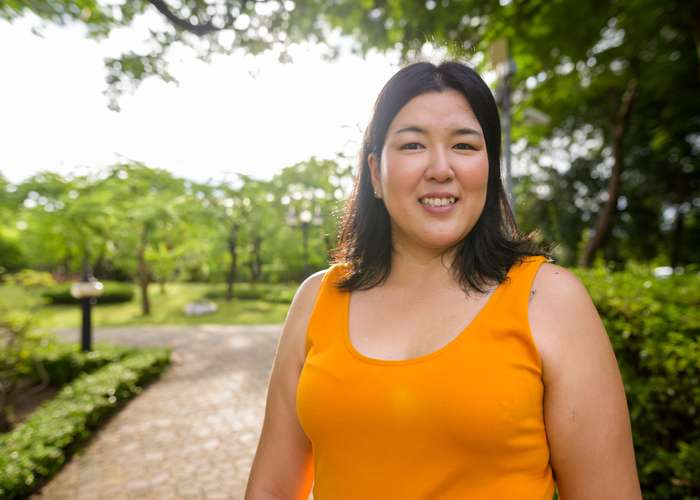 Avoid gaining weight for Alzheimer: overweight woman taking picture outdoor.