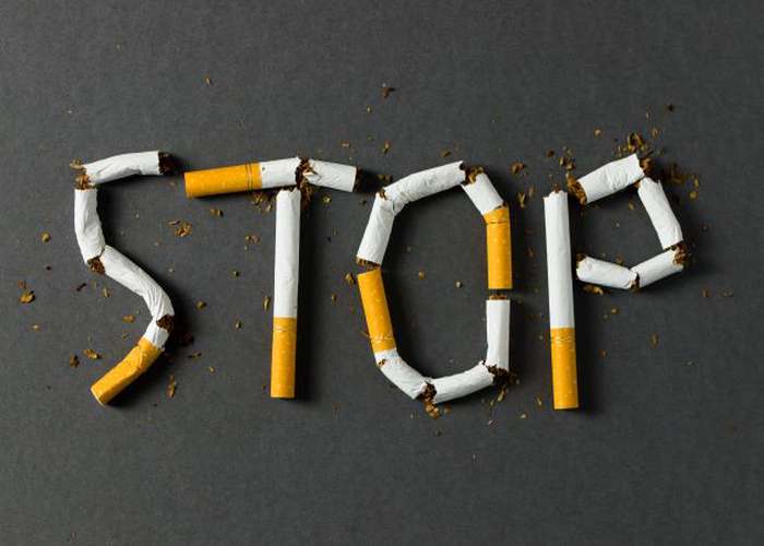 Don't smoke for heart disease because it blocks the arteries: broken cigarettes in the drawing a STOP smoking sign.