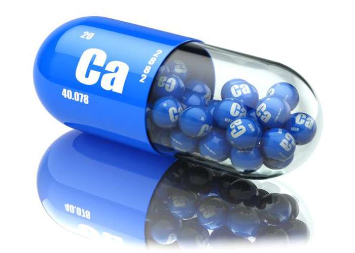 Blue calcium vitamin pill, half of it is transparent and showing many calcium particles inside.