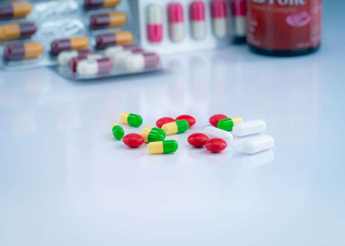 Avoid excess iron supplements for Alzheimer: different iron supplements in different colors, on a table.