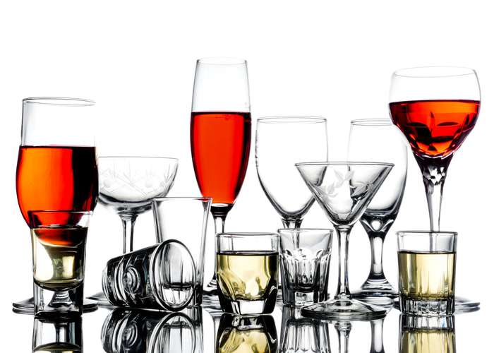 Avoid alcohol for hemorrhoids: glasses of alcohol on a bar.