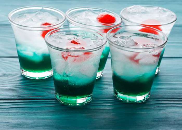 Avoid alcohol for IBS: glasses of green alcohol drink.