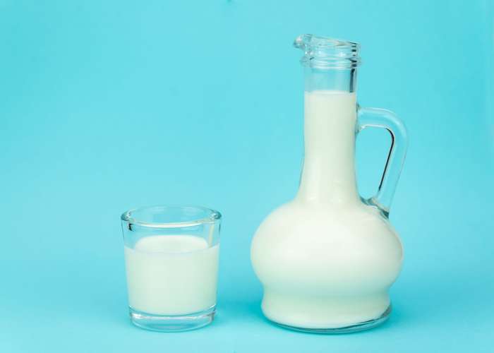 Avoid casein and dairy products for IBS: milk in a bottle and a glass.